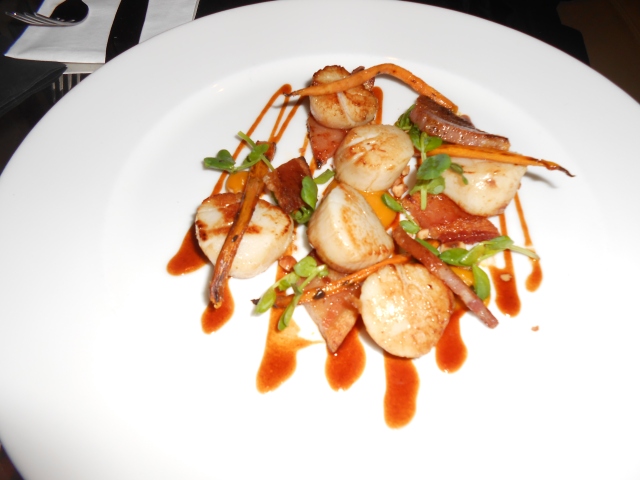 A plate of scallops with bacon in bar at Chiswell Street Dining Rooms